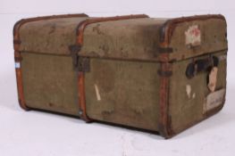 A mid 20th century green de-mob canvas and wooden bound steamer trunk with clasps to centre.