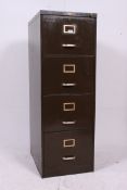 A vintage industrial metal four drawer filling cabinet.