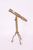 A 20th century model brass desktop telescope on tripod base.