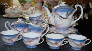 A 20th century Japanese translucent teaset, comprising of teacups, teapot and saucers etc.
