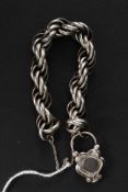 A 20th century silver (tested) although unmarked white metal hair locket on a twist chain.