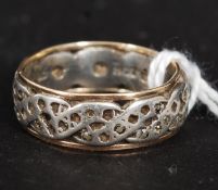 A ladies 9ct gold and silver ring having gold banded edges with silver swirl set centre. Size N/O.
