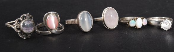 A collection of contemporary silver ladies dress rings to include opal set 3 stone ring,