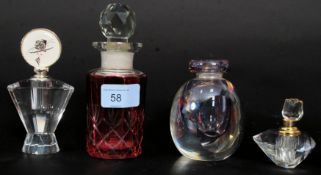 A collection of 4x vintage perfume bottles, one being cranberry glass.