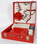 A vintage retro Brexton picnic hamper in red vinyl case dating to the 1950's