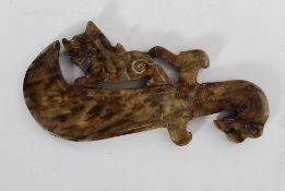 A decorative well carved marble Dragon resting on a sword