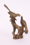 A Chinese oriental brass figure of two birds upon a tree. Character mark to base.