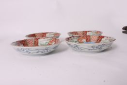 A collection of 4 19th century Kutani bowls having a red geometric pattern with pagodas etc