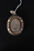 A fantastic Victorian large silver hallmarked locket of oval shape moulded in relief in the rococo