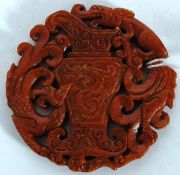 A carved Jade roundel having fret pierced centre of scroll work and dragons