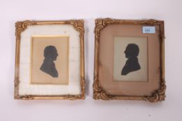 A pair of early 20th century Irish silhouettes being framed and glazed bearing original retailers