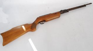 A 20th century Tornado air rifle with wooden stock being marked to the barrel