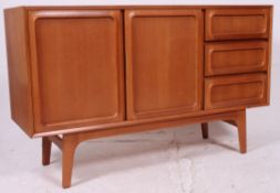 A 1970's Danish teak style sideboard having a series of drawers and cupboards to the wide body