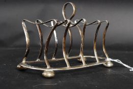 A hallmarked silver art deco style toast / letter rack or stylised form, with hoop handle to top.
