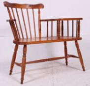 A retro 1980's country style pine telephone seat being raised on bobbin turned legs with spindle