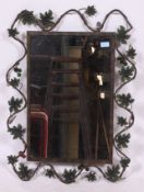A 20th century Rococo style contemporary wall mirror adorned with scroll work frame having glass