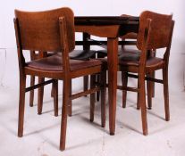 A 1930's Art Deco style dining room suite comprising draw leaf dining table raised on angled