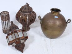 A derorative hand beaten double handled tall copper vase along with three Morrocan metal work ang