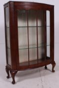 A 1930's Art Deco walnut bow front display cabinet.