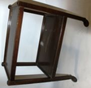 A vintage 1930's oak twin tier trolley having castors to the base with gallery sided tiers.