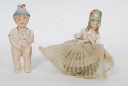 A ceramic 19th century ceramic pin cushion doll SS76 Germany together with a porcelain continental