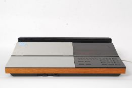 A retro 1970's Bang & Olufsen Beomaster 6000 stereo system having teak finish.