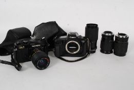 A Chinon CE2 Memotron slr camera along with a Canon EOS camera with Sirius lens  35-135mm,