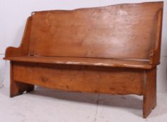 A 1950's solid elm wood hall settle bench. Of plain form with panelled seat and back rest.