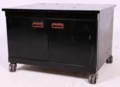 A retro 1970's metal low office filing cabinet on castors having applied numbers to the panels.