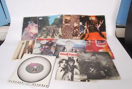 A collection of vinyl record albums to include The Beatles, Small faces, Queen, The Who,