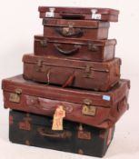 A good collection of vintage suitcases to include leather examples along with graduating size