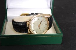 A 9ct gold gentlemans Eterna swiss made wristwatch / watch set over a leather strap.