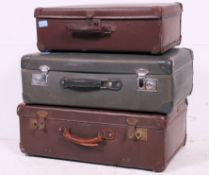 A stack of 3 vintage 20th century suitcases to include mid 20th century 1950's example and others.