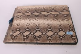 An Edwardian faux snakeskin postcard album,