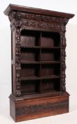 19th century Victorian Jacobean revival carved oak bookcase cabinet.