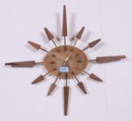 A retro 1970's quartz movement sunburst wall clock. Measures: 49cm x 54cm.