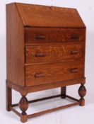 A 1930's Art Deco golden oak bureau having fall front slope with appointed interior set within.