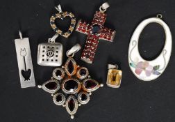 A collection of 7x silver and white metal 925 pendants, comprising of; a button locket, crucifix,