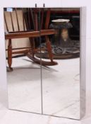 A contemporary mirrored metal bathroom cabinet, comprising of two shelves to the interior.