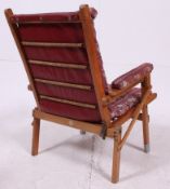 A 1950's retro folding campaign style upholstered beech wood armchair with the original upholstery