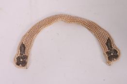 A stunning Edwardian ladies silk and seed pearl collar. Finished with a decorative clasp to the end.