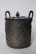 A 20th century pewter art nouveau style biscuit barrel, standing on decorative feet with top.