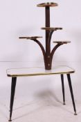 A 1950's formica and ebonised wood plant stand table of rectangular form with tapered supports