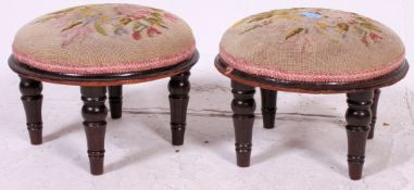 2 vintage tapestry needlepoint upholstered footstools raised on turned stub legs.