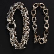 A large silver heavy curb link bracelet together with another curb linked 925 silver bracelet.