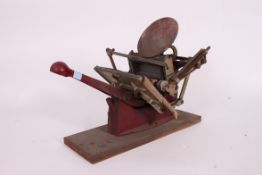 A vintage table top 1960's printing press with mechanism and handle on plinth base