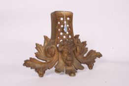 A gilded metal Victorian  large fire hearth ornament having acanthus leaf design with the face of