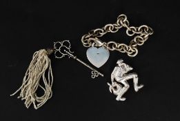 A silver sterling brooch in the form of the pied piper together with a Tiffany and co silver metal