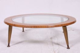 A 1970's  low circular vintage Teak and Glass coffee table on gold stub tapered legs having cap