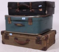 A stack of 3x suitcases to include canvas demob case and two other vintage suitcases.